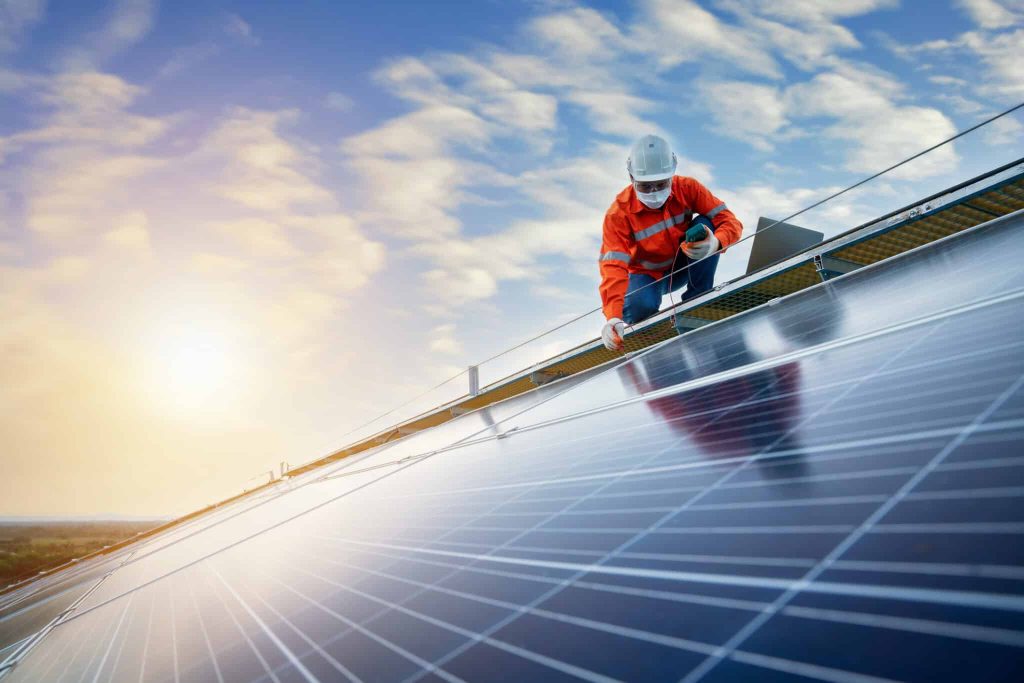 engineer working use a power check machine on checking power of solar panels on the roof, Solar energy technology concept