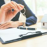 House,Model,With,Real,Estate,Agent,And,Customer,Discussing,For